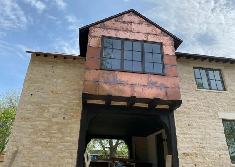 Copper metal panel facade on a stone building for Skylight Installation in Belle Haven